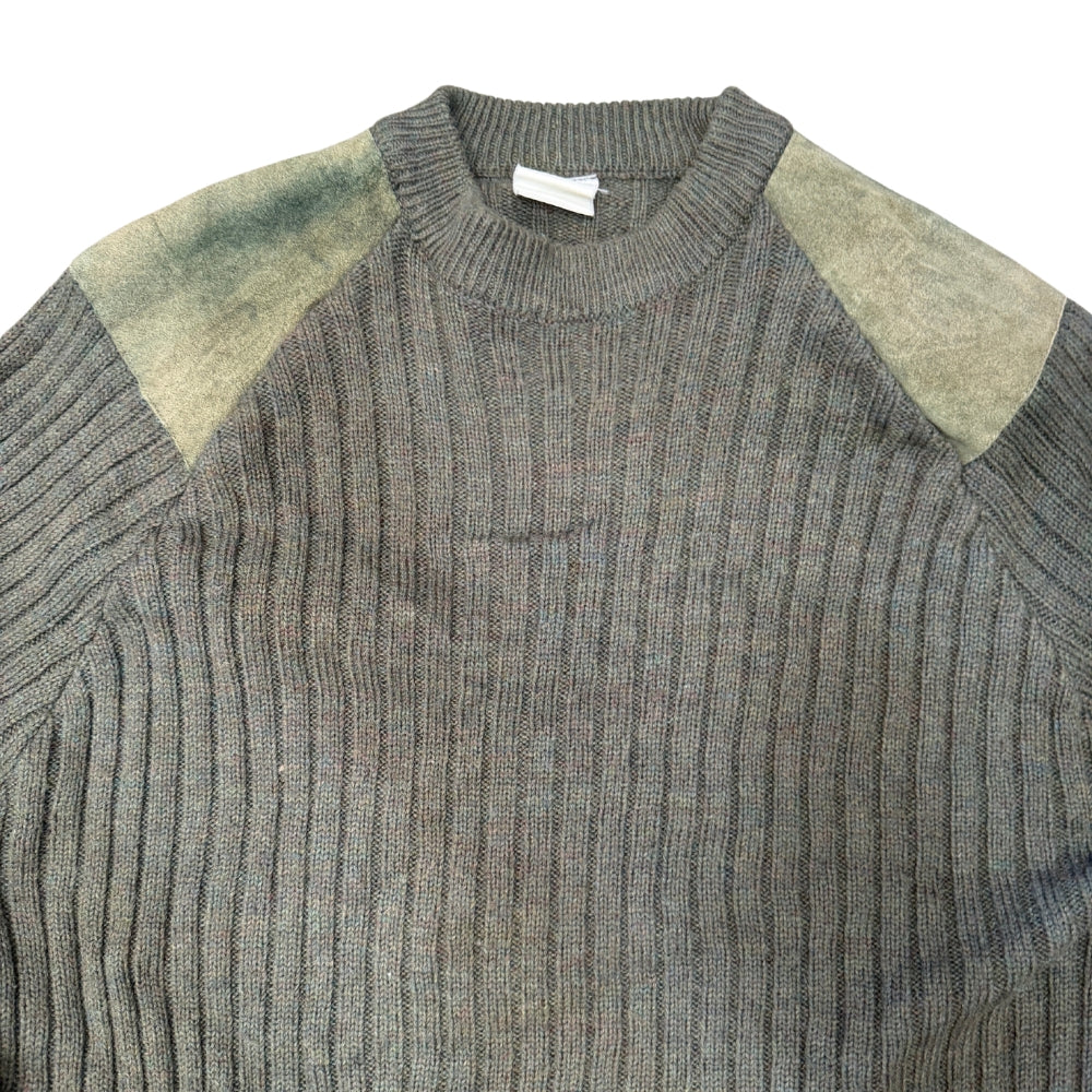 A close-up of a ribbed knit sweater in heather gray with muted olive-green shoulder panels, shown against a plain white background.